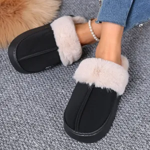 Close-up of cozy black winter slippers with plush faux fur lining and thick sole