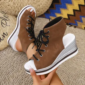 Detail view of brown lace-up wedge sandals featuring an open-toe and silver platform