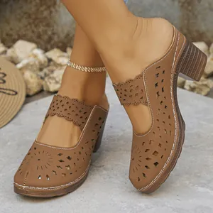 Close-up of brown laser-cut high heel mules featuring elegant floral hollow patterns