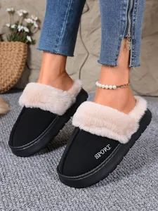 Close-up of black winter slippers with plush faux fur trim and SPORT embroidery detail