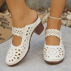 Close-up detail of women's elegant cream hollow-out chunky heel mules for summer