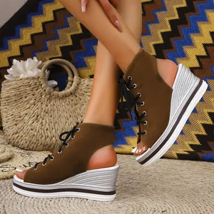 Close-up detail shot of brown lace-up wedge sandals featuring silver braided platform soles.