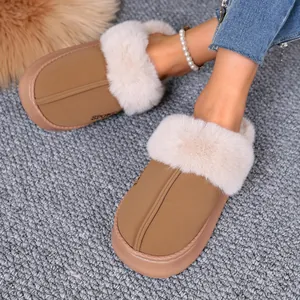 Close-up detail of winter home slippers with plush faux fur trim and cozy tan finish.