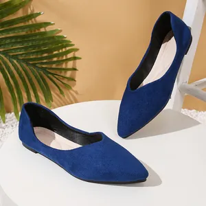 Detail view of royal blue suede pointed-toe flats with soft soles for elegant women