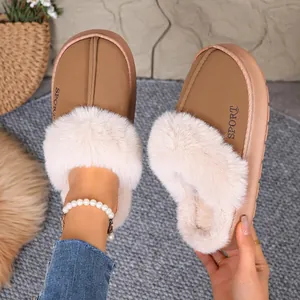 Close-up of stylish warm winter home slippers with thick fur trim and SPORT logo detail.
