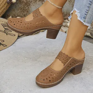 Detailed view of women's brown hollow-out closed-toe mules with chunky high heels and laser-cut design