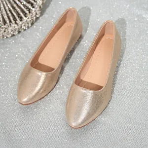 Detail view of stylish champagne gold glittery women's pointed toe ballet flat shoes