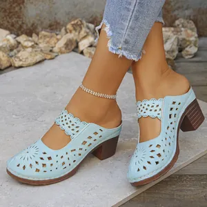 Stylish light blue hollow-out block heel mules with elegant laser-cut floral patterns for summer