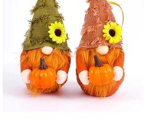 Detailed close-up view of festive Thanksgiving gnomes decorated with sunflowers holding pumpkins