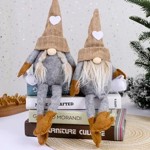 Pair of faceless Christmas gnomes with knitted heart hats for holiday home decor.