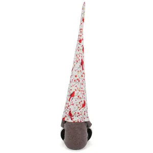 Detail view of long-hatted Christmas gnome with red cardinal and holly berry pattern