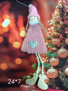 Adorable pink plush angel Christmas ornament hanging on a festive decorated holiday tree