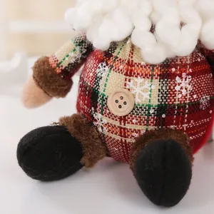 Macro detail of a plush Christmas doll featuring red plaid fabric and white curly beard.