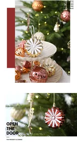 Detailed view of hand-painted star Christmas ornaments in a festive tree setting.