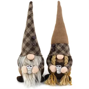 Close-up detail of two coffee-themed plush gnomes holding miniature white coffee mugs