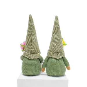 Close-up back view of spring green gnomes with floral accents and herringbone hats