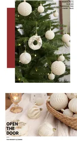 Detailed view of elegant cream flocked Christmas ball ornaments on a tree and in a basket