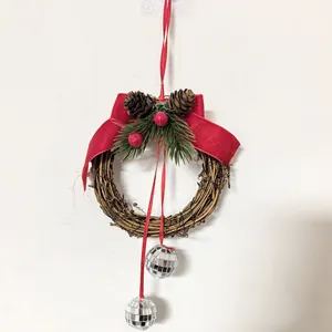 Detailed view of handmade Christmas vine wreath with red velvet bow and disco balls