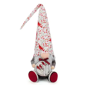 Detailed view of Christmas gnome doll with cardinal bird and holly berry hat