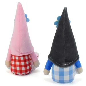 Rear detail view of two cute plush gnome dolls with pink and black pointed hats.