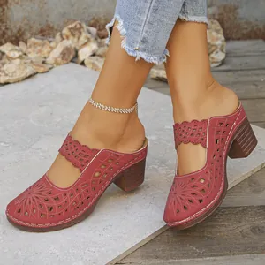 Close-up detail of women's burgundy hollow-out closed-toe mules with chunky heels