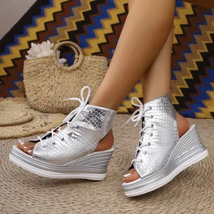 Stylish silver crocodile pattern wedge sandals featuring lace-up front and peep toe design