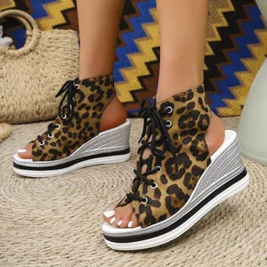 Close-up of leopard print lace-up peep-toe wedge sandals with stylish platform sole