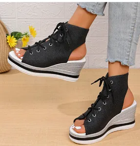 Stylish women's black wedge sandals featuring a lace-up design and open-toe style