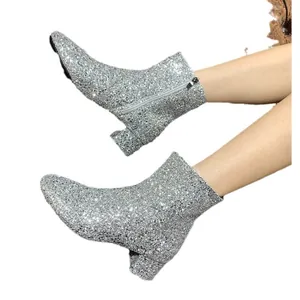 Sparkling silver sequined ankle boots with chunky mid heels and side zipper closure.