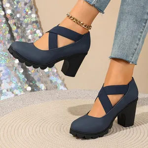 Detail of blue platform high heels with cross straps and chunky black sole.