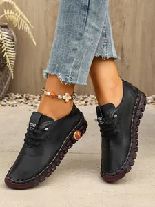 Mocasines informales de cuero negro para mujer con detalles cosidos a mano