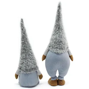 Back view of two grey plush gnome dolls with fuzzy hats and striped sleeves