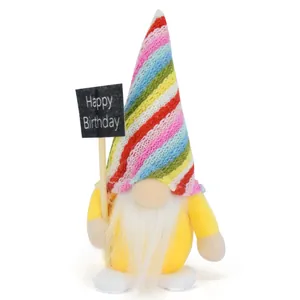 Close-up of yellow birthday gnome doll holding a Happy Birthday sign for party decor