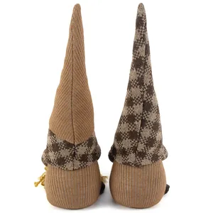 Detailed back view of two coffee-themed knitted gnome dolls with tall patterned hats