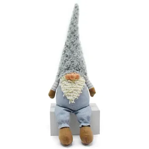 Detail shot of a gray plush gnome doll with long beard and striped clothes on white seat