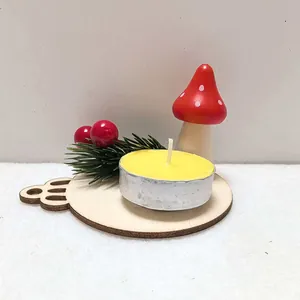 Close-up of yellow tea light candle on wooden base with decorative mushroom and pine.