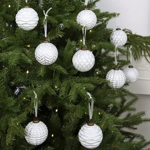 Set of white vintage European Christmas ornaments with various patterns on tree