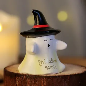 Cute resin Halloween ghost figurine with black witch hat displayed on wooden base
