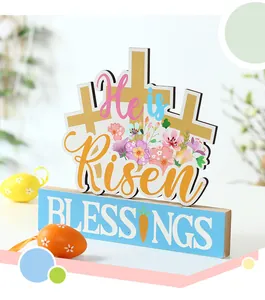 Detailed macro view of a wooden Easter decoration featuring 'He is Risen' text and florals
