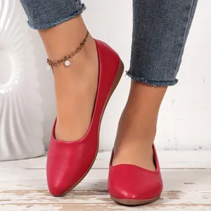 Elegant red pointed-toe flat loafers in pebbled leather shown on model for casual wear