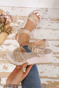 Detailed shot of stylish beige platform wedge sandals featuring adjustable metal buckles