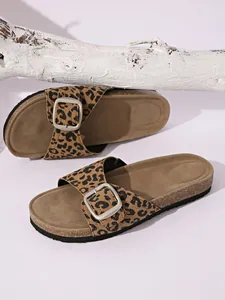 Detailed shot of stylish leopard print slides with an adjustable silver metal buckle