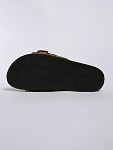Detail view of the black wavy anti-slip sole on a leopard print buckle slide
