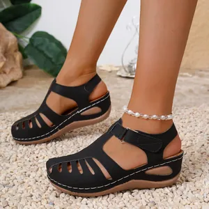 Stylish black wedge platform sandals for women with intricate hollow out and stitching details.
