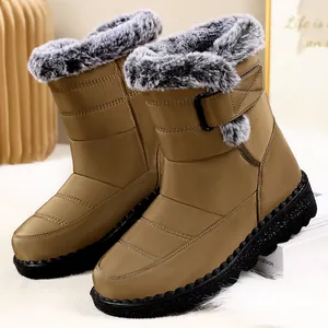 Close-up of brown women's snow boots featuring grey fur lining and velcro strap closure