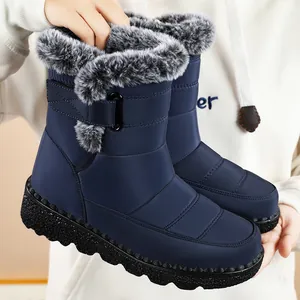 Close-up of blue waterproof snow boots with faux fur trim and velcro strap