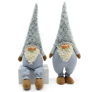 Detailed view of two charming grey plush gnome dolls with resin faces and textured hats.