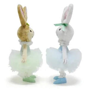 Side profile view showing the delicate detail of two plush Easter bunnies in pastel tutus
