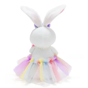 Back view of Easter plush rabbit decor featuring a vibrant rainbow tulle tutu skirt
