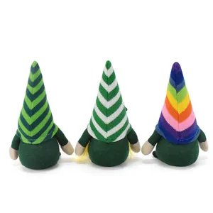 Back view of three St. Patrick's Day gnomes with striped and rainbow knitted hats